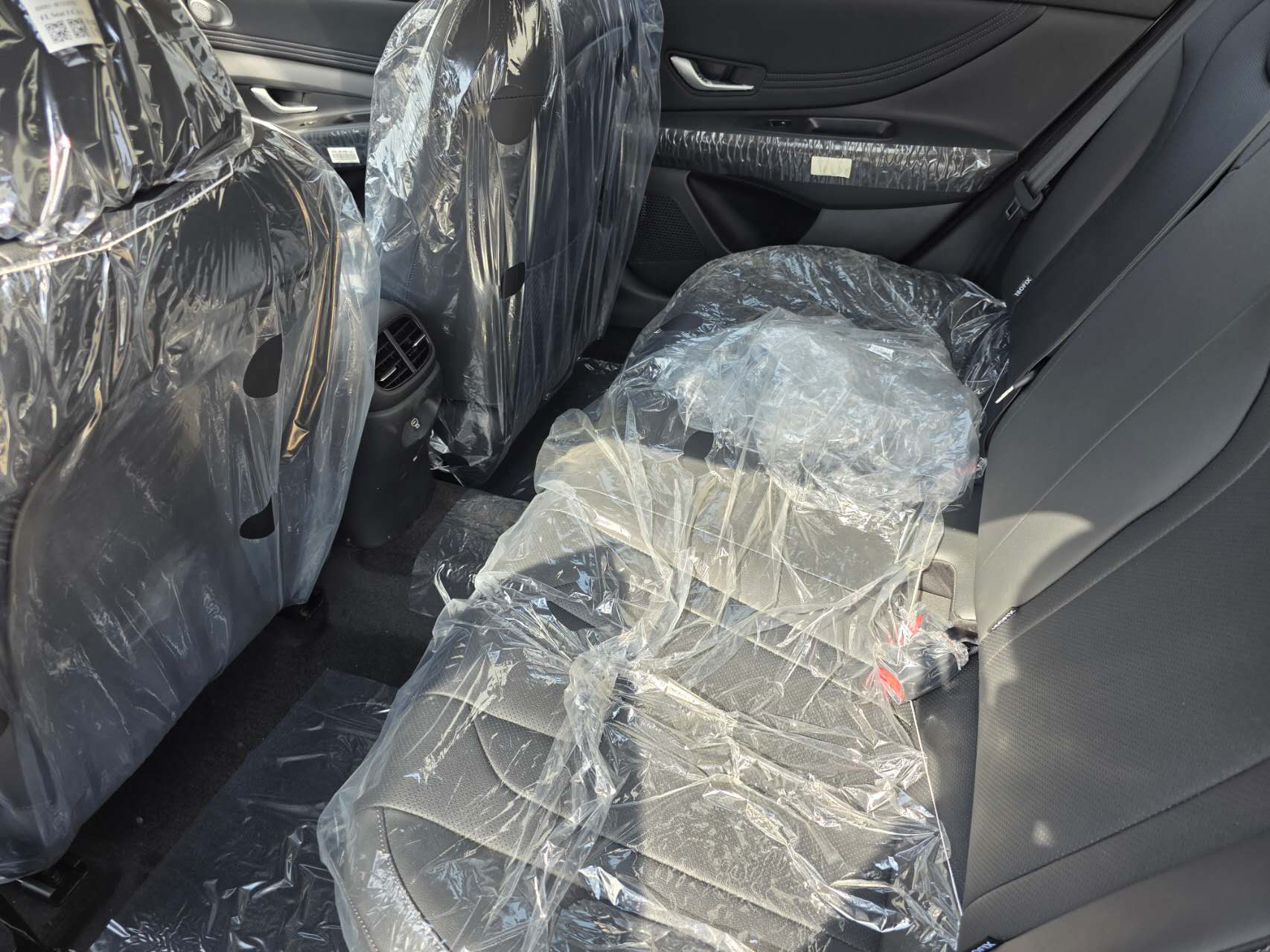 Hyundai Elantra rear passenger area with covered seats and rear air vents